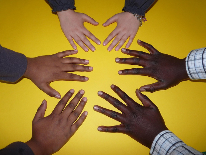 Women holding hands in supportive circle